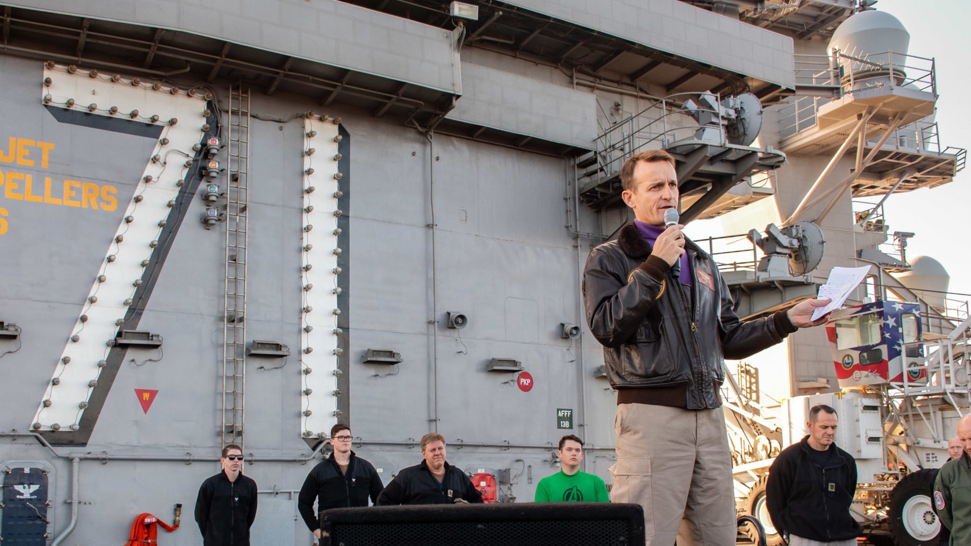 191215-N-KB540-3097 PACIFIC OCEAN (Dec. 19, 2019) Capt. Brett Crozier, commanding officer of the aircraft carrier USS Theodore Roosevelt (CVN 71), gives remarks during an all-hands call on the ship’s flight deck Dec. 15, 2019. Theodore Roosevelt is underway conducting routine training in the Eastern Pacific Ocean. (U.S. Navy photo by Mass Communication Specialist Seaman Alexander Williams)