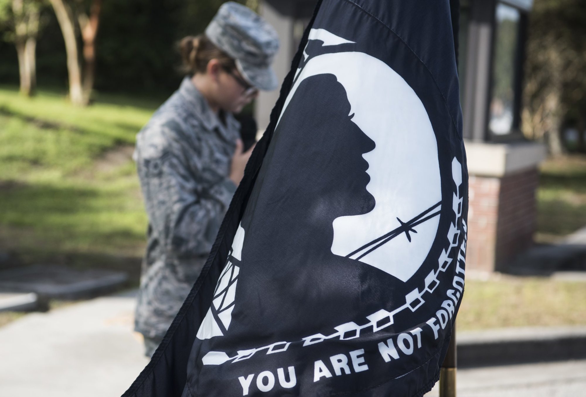 Airman 1st Class Summer Bell, 437th Maintenance Squadron munitions controller, reads the names of prisoners of war and those missing in action Sept. 28, 2018, at Joint Base Charleston, S.C. The National League of Families’ POW/MIA flag symbolizes the United States’ resolve to never forget prisoners of war or those who served their country in conflicts and are still missing.