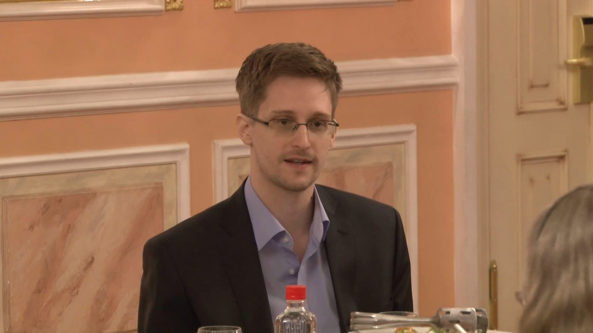 Edward Snowden receives the Sam Adams award for Intelligence Integrity in Moscow. Photo by TheWikiLeaksChannel on YouTube screenshot, via Wikimedia Commons.