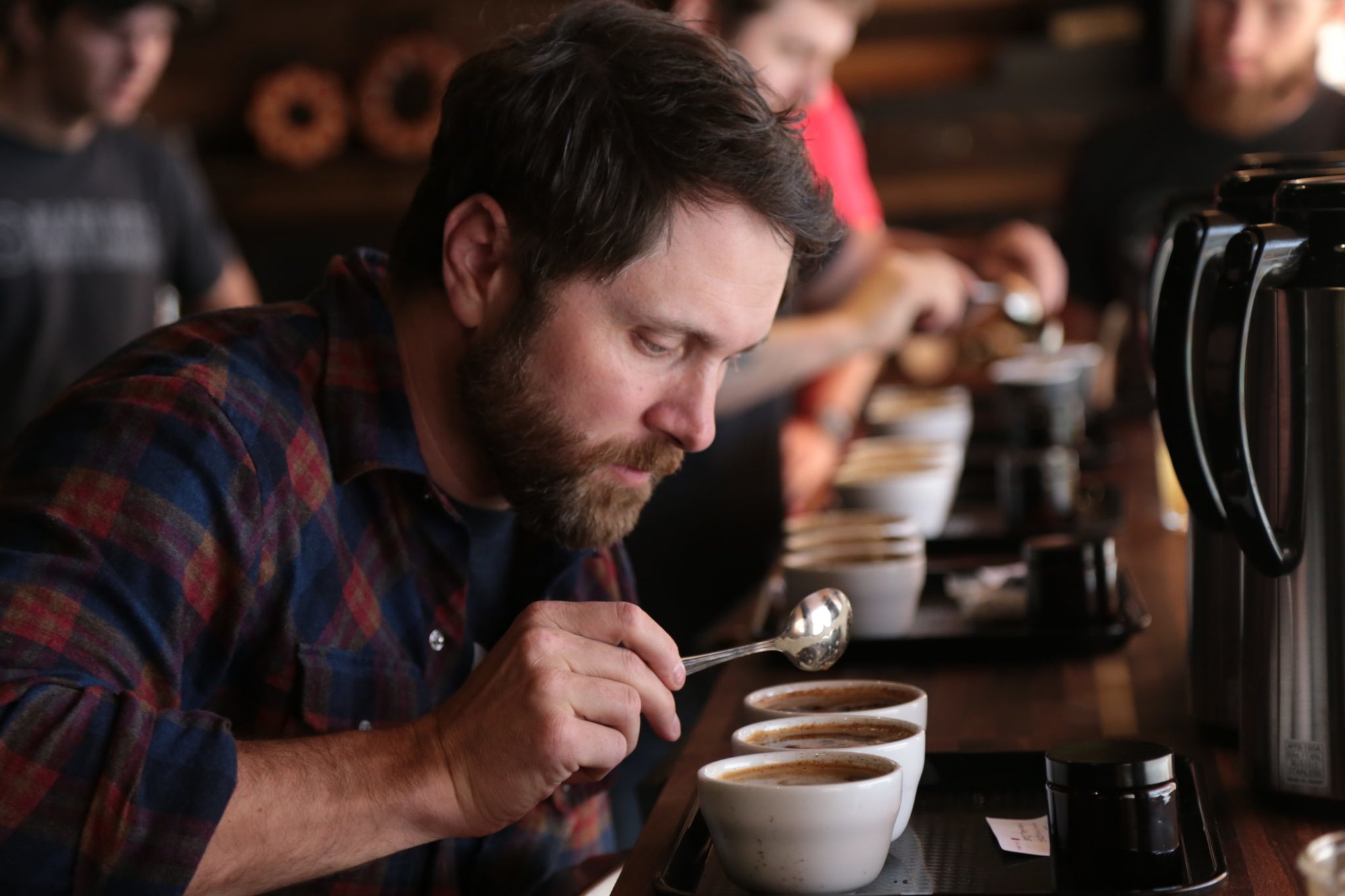 BRCC founder and CEO Evan Hafer cupping a new brew. Photo courtesy of Black Rifle Coffee Company.
