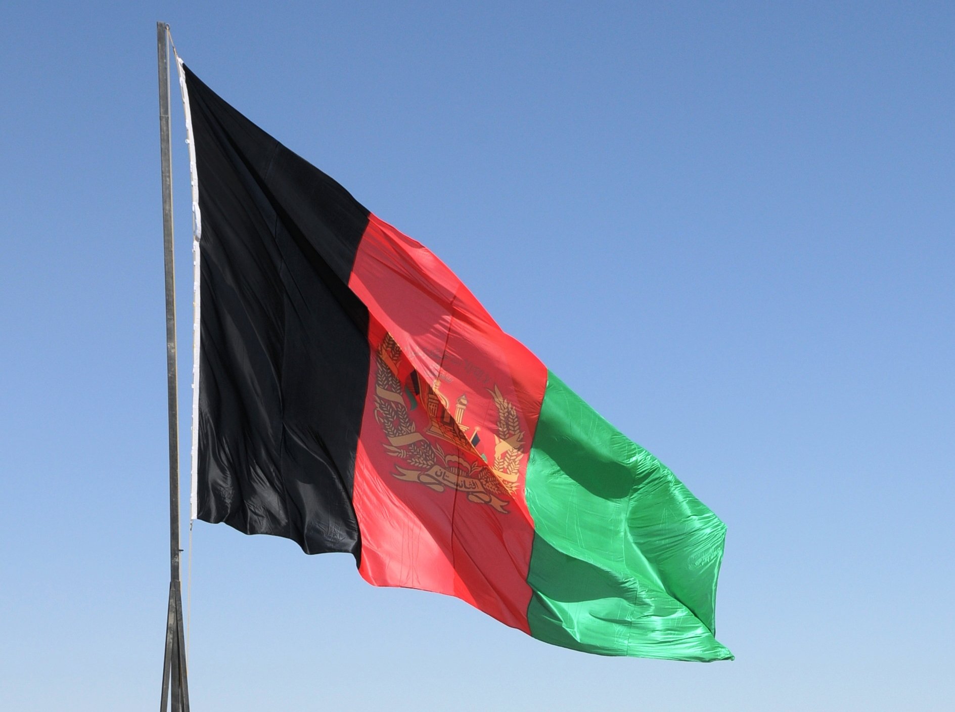 The Afghanistan national flag waves in the breeze during a ceremony in Sangsar, Sept 19, 2011. Sangsar is the former home of Taliban founder, Mullah Omar.