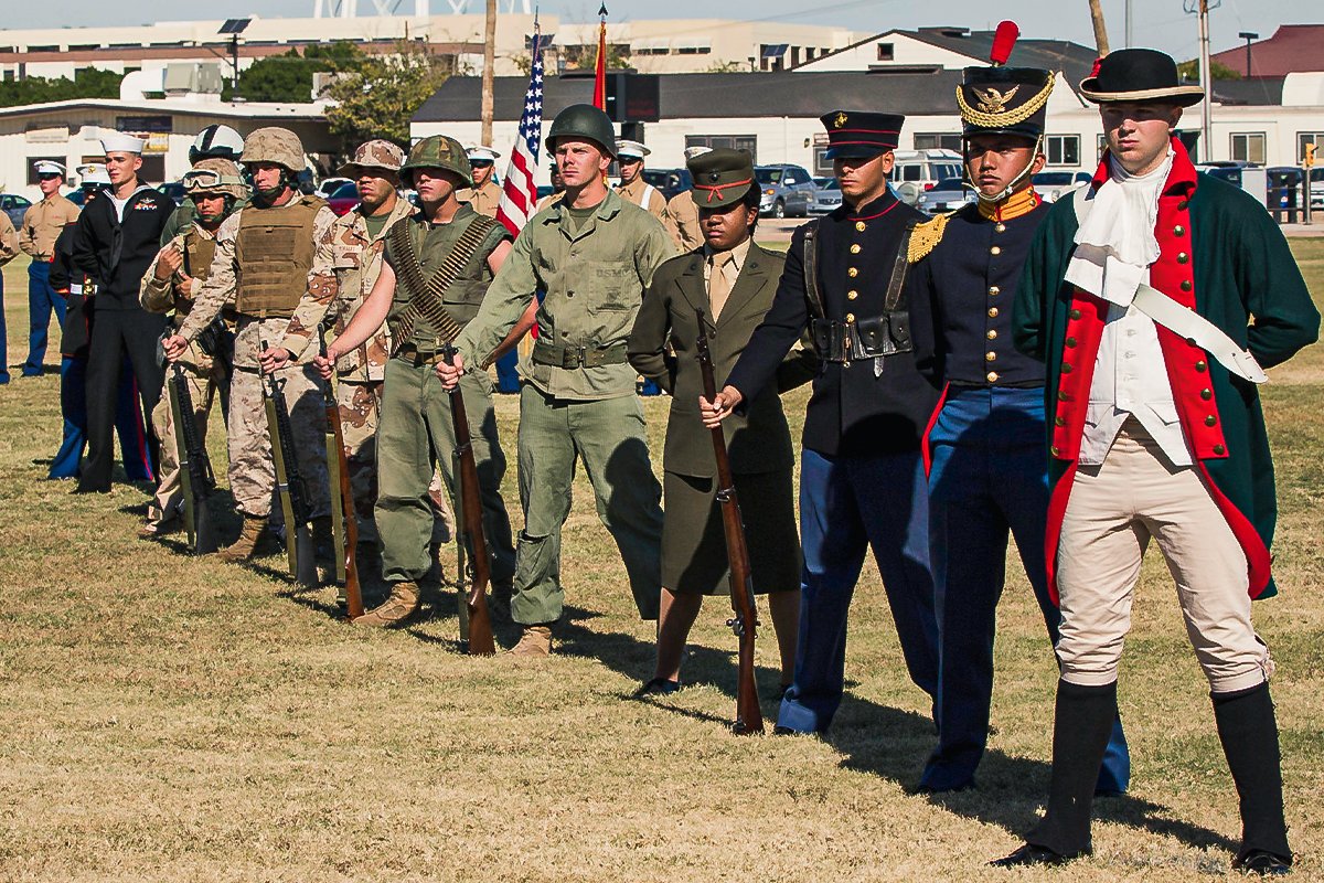 Marines from Marine Corps Air Station Yuma, Ariz. stand at parade rest during the 238th Marine Corps Birthday uniform pageant and cake cutting ceremony held at the parade deck on Thursday. The pageant consisted of Marines dressed in historical uniforms that have been worn throughout the Marine Corps’ 238 years of existence. The pageant commemorates the long lineage of men and women who have filled the Corps’ ranks for more than two centuries. Photo by PFC Reba James, courtesy of DVIDS.