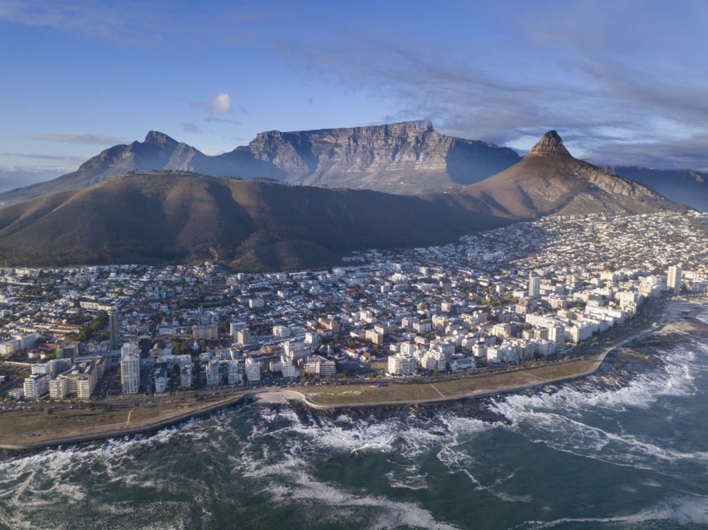 Aerial view over Cape Town, South Africa with Table Mountain in the distance. Adobe Stock photo.