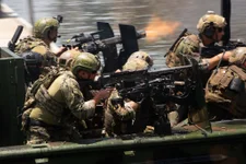 Multinational Special Operations Forces conduct an amphibious assault from a Special Operations Craft – Riverine boat during a capabilities demonstration as part of the 2018 International Special Operations Forces week in downtown Tampa, Fla., May 23, 2018. ISOF is the premier conference for the SOF community to advance the understanding of international SOF challenges. (Photo by U.S. Air Force Master Sgt. Barry Loo)
