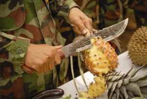 A Thai reconnaissance Marine cuts one of the few fruits his American counterparts were familiar with.