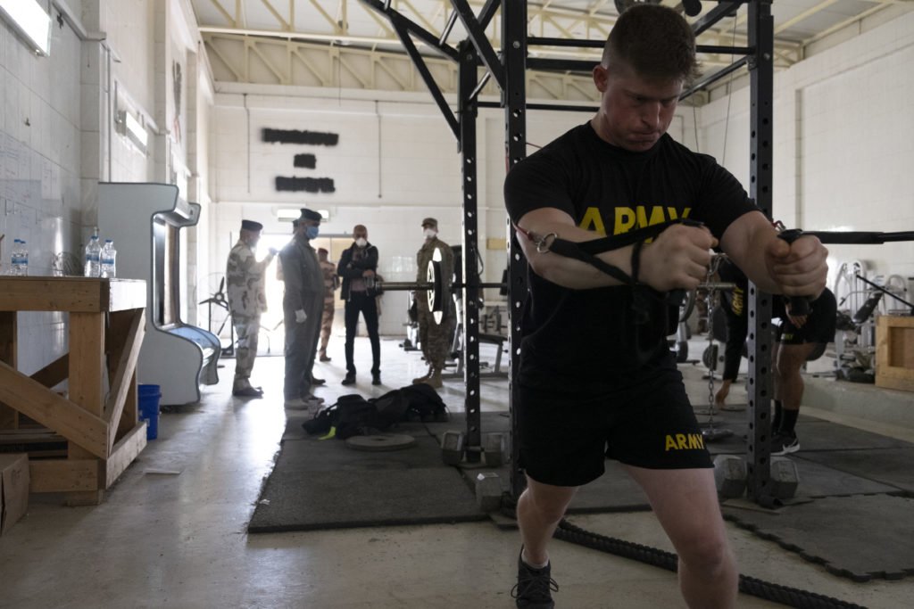 Iraqi officers survey the gym as American soldiers continue their daily exercise routine. Photo by Kevin Knodell/Coffee or Die.