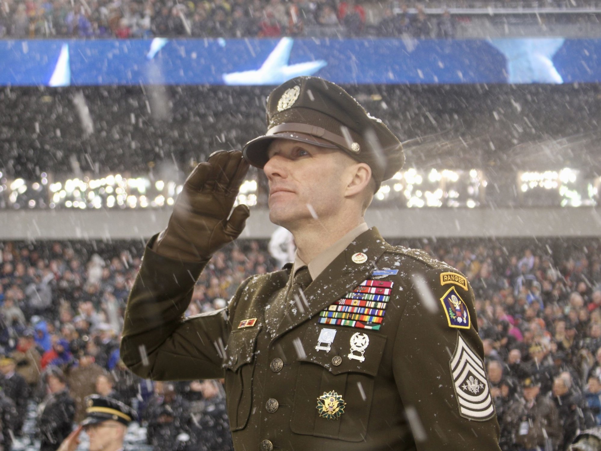 Sergeant Major of the Army Dan Dailey salutes the Anthem pre-kickoff during the Army-Navy game at Lincoln Financial Field in Philadelphia, Pennsylvania Dec. 9, 2017. SMA Dailey displayed the Army’s proposed ‘Pink and Green’ daily service uniform, modeled after the Army’s standard World War II-era dress uniform. (U.S. Army photo by Ronald Lee)