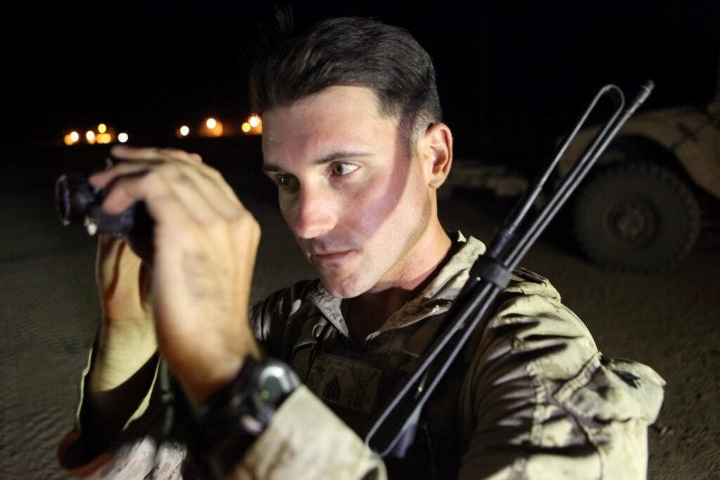 Sergeant Dominic Sharpsteensurina, a native of Apple Valley, California, and an assault section leader with Weapons Platoon, Charley Company, 1st Battalion, 7th Marine Regiment, inspects his PVS-14 night vision system aboard Camp Dwyer, Helmand province, Afghanistan, Sept. 21, 2014. Photo by Cpl. Cody Haas/U.S. Marine Corps, Released.