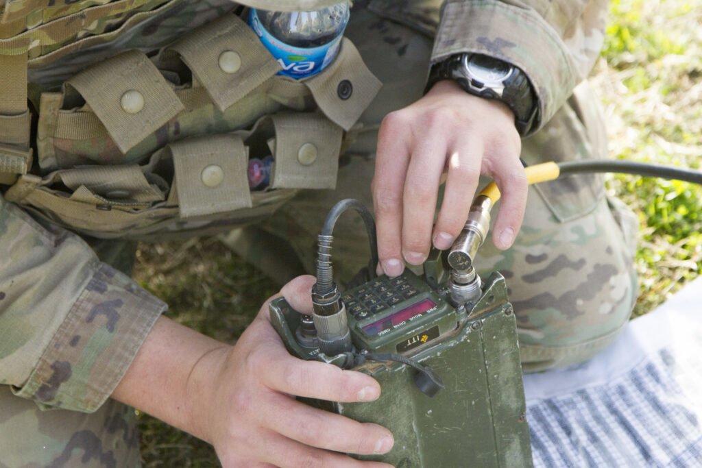 A soldier programs a radio for communications operations during the 2018 Iron Ram competition at Kuwait Naval Base, Kuwait, Jan. 5, 2018. Photo by Sgt. Thomas X. Crough, USARCENT PAO/U.S. Army.