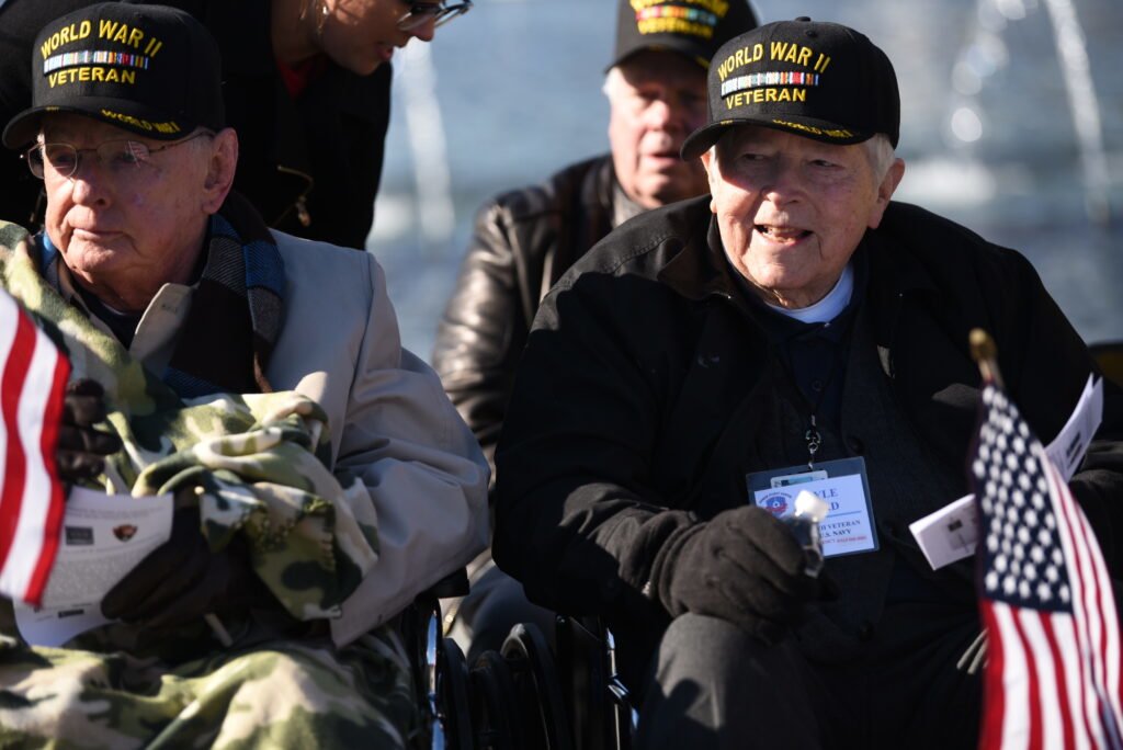 World War II veterans Buddy Sutton and Lyle Bird are guests of honor at the Pearl Harbor Day event at the World War II Memorial, Washington, D.C., Dec. 7, 2018. Photo by Lisa Ferdinando/DOD, courtesy of DVIDS. 