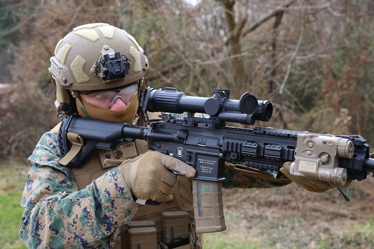 CWO4 Dave Tomlinson, infantry weapons officer at Marine Corps Systems Command, demonstrates the Squad Common Optic attached to the M27 Infantry Automatic Rifle, Feb. 10, aboard Marine Corps Base Quantico, Virginia. The SCO is an improved optic that improves target acquisition and probability of hit with infantry assault rifles. Marine Corps Systems Command began fielding the system to infantry and infantry-like units this year. (U.S. Marine Corps photo by Matt Gonzales)