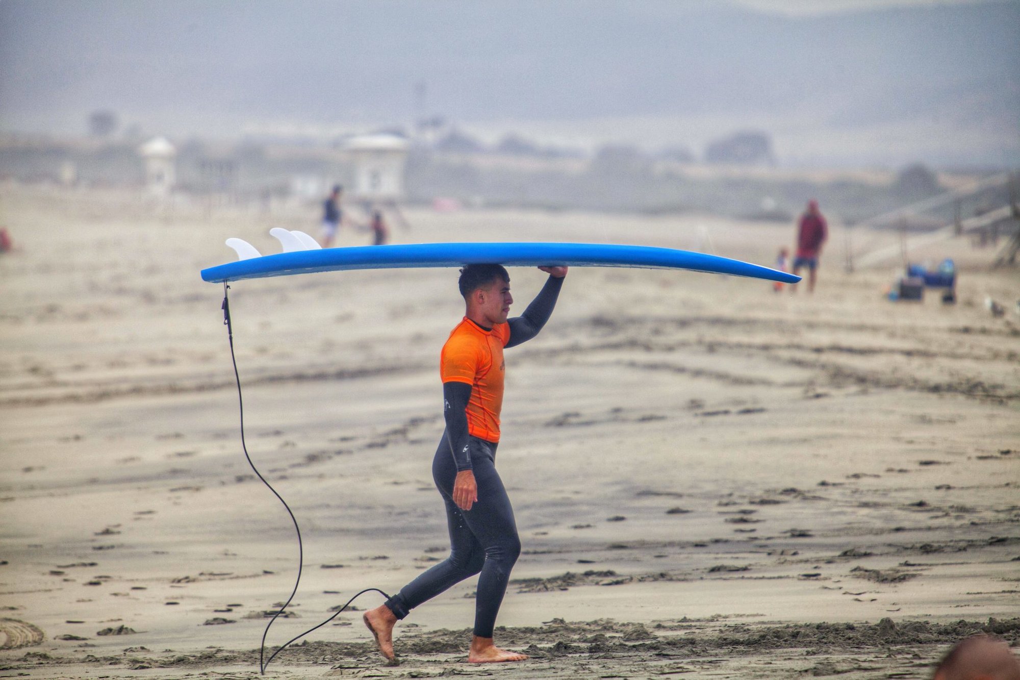 U.S. Marine carries a surfboard after surfing during the annual Commanding General’s (CG’s) Cup Surfing Competition, at the Del Mar Beach Resort on Marine Corps Base Camp Pendleton, California, June 19, 2019. The CG’s Cup is a series of competitive sporting events, which promotes combat readiness, resiliency, esprit de corps, leadership, teamwork and loyalty for active-duty Marines and Sailors through participation in sports.  (Photo by Ismael Pena)