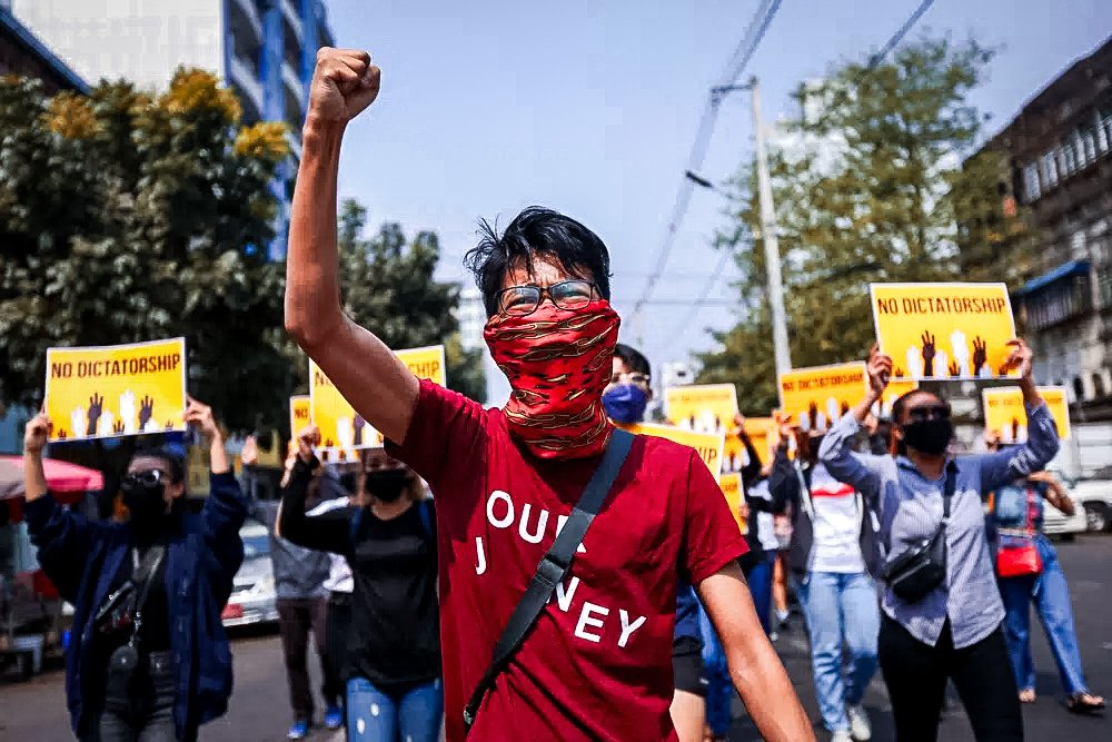 Anti-coup protesters gesture during a march in Yangon, Myanmar.