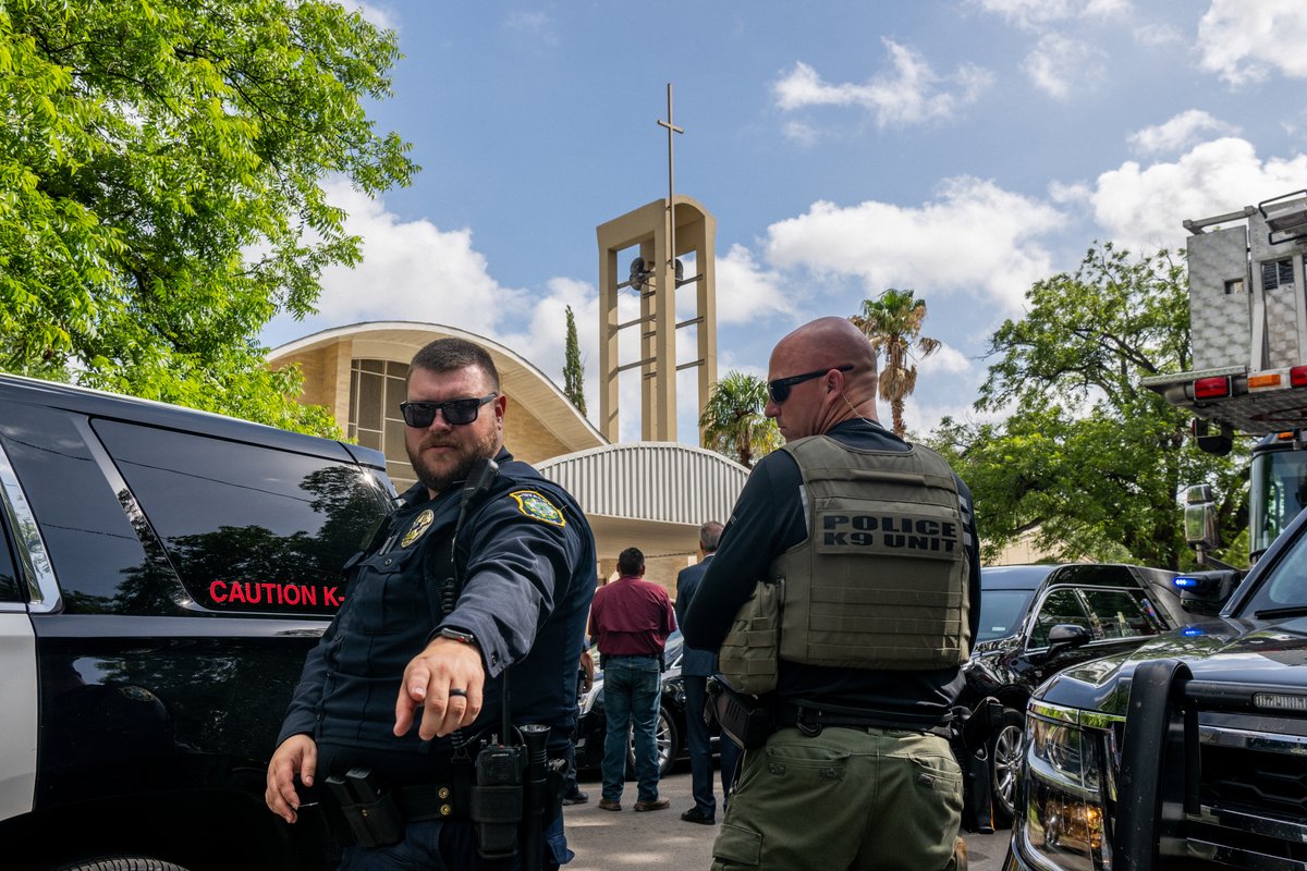 Law enforcement officers obstruct the view from members of the press during the joint funeral service for teacher Irma Garcia and her husband Joe Garcia on June 01, 2022, in Uvalde, Texas. Irma Garcia was killed in the mass shooting at Robb Elementary School and her husband died a few days later. Photo by Brandon Bell/Getty Images.