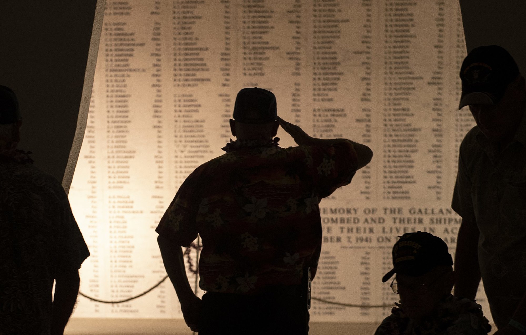 Edward Hoeschen salutes the wall of names at the USS Arizona Memorial during the 78th Anniversary Pearl Harbor Remembrance Commemoration Dec. 7, 2019. US Navy photo by Mass Communication Specialist 1st Class Holly L. Herline.