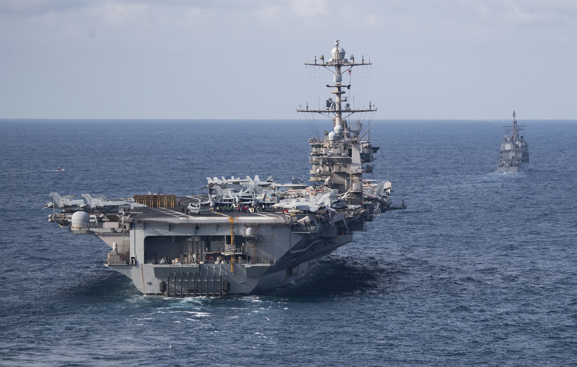 ATLANTIC OCEAN (July 18, 2019) The Nimitz-class aircraft carrier USS Harry S. Truman (CVN 75), front, and the Ticonderoga-class guided-missile cruiser USS Normandy (CG 60) transit the Atlantic Ocean. Harry S. Truman is underway conducting composite training unit exercise with the Harry S. Truman Carrier Strike Group. U.S. Navy photo by Mass Communication Specialist 2nd Class Scott Swofford/Released.