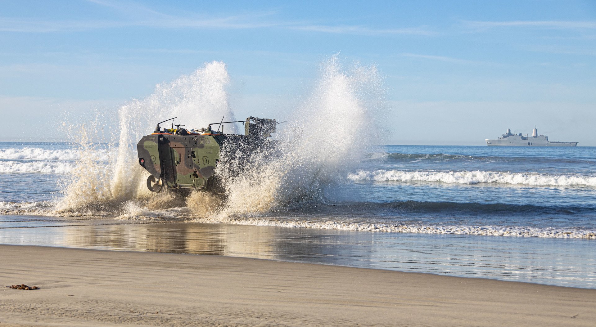 US Marines assigned to the 3rd Assault Amphibian Battalion, 1st Marine Division, drive an Amphibious Combat Vehicle into the water toward the USS Anchorage at Camp Pendleton, California, Feb. 12, 2022. US Marine Corps photo by Lance Cpl. Willow Marshall.