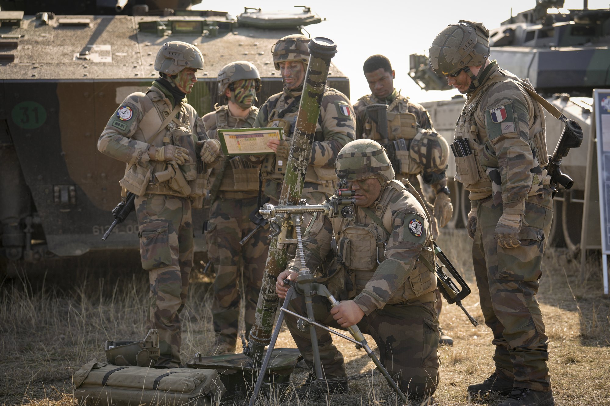 French serviceman operate a mortar during a joint French US exercise involving HIMARS and MLRP rocket launchers at a firing range in Capu Midia, on the Black Sea shore, Romania, Thursday, Feb. 9, 2023. U.S. and French troops that are part of a NATO battlegroup in Romania held a military exercise on Thursday to test the 30-nation alliance's eastern flank defenses, as Russia's full-scale invasion of neighboring Ukraine nears its one-year anniversary. (AP Photo/Vadim Ghirda)