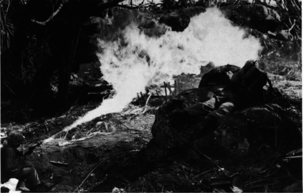 Two flamethrower operators team up to send twin streams of burning liquid into well-concealed Japanese positions blocking the way to Mount Suribachi. Photo courtesy of Department of Defense (USMC) 110599.