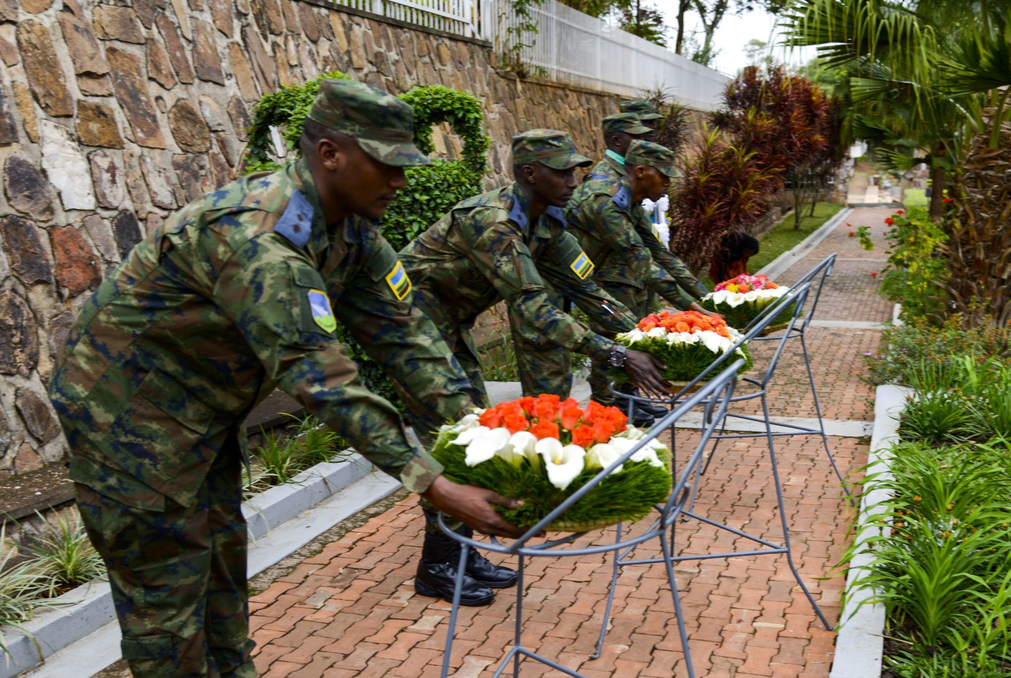 Members of the Rwanda Defence Force pick up wreaths during a wreath laying ceremony at the Kigali Genocide Memorial in Kigali, Rwanda, March 4, 2019. The memorial is one of more than 200 memorials throughout Rwanda. (U.S. Air Force photo by Tech. Sgt. Timothy Moore)
