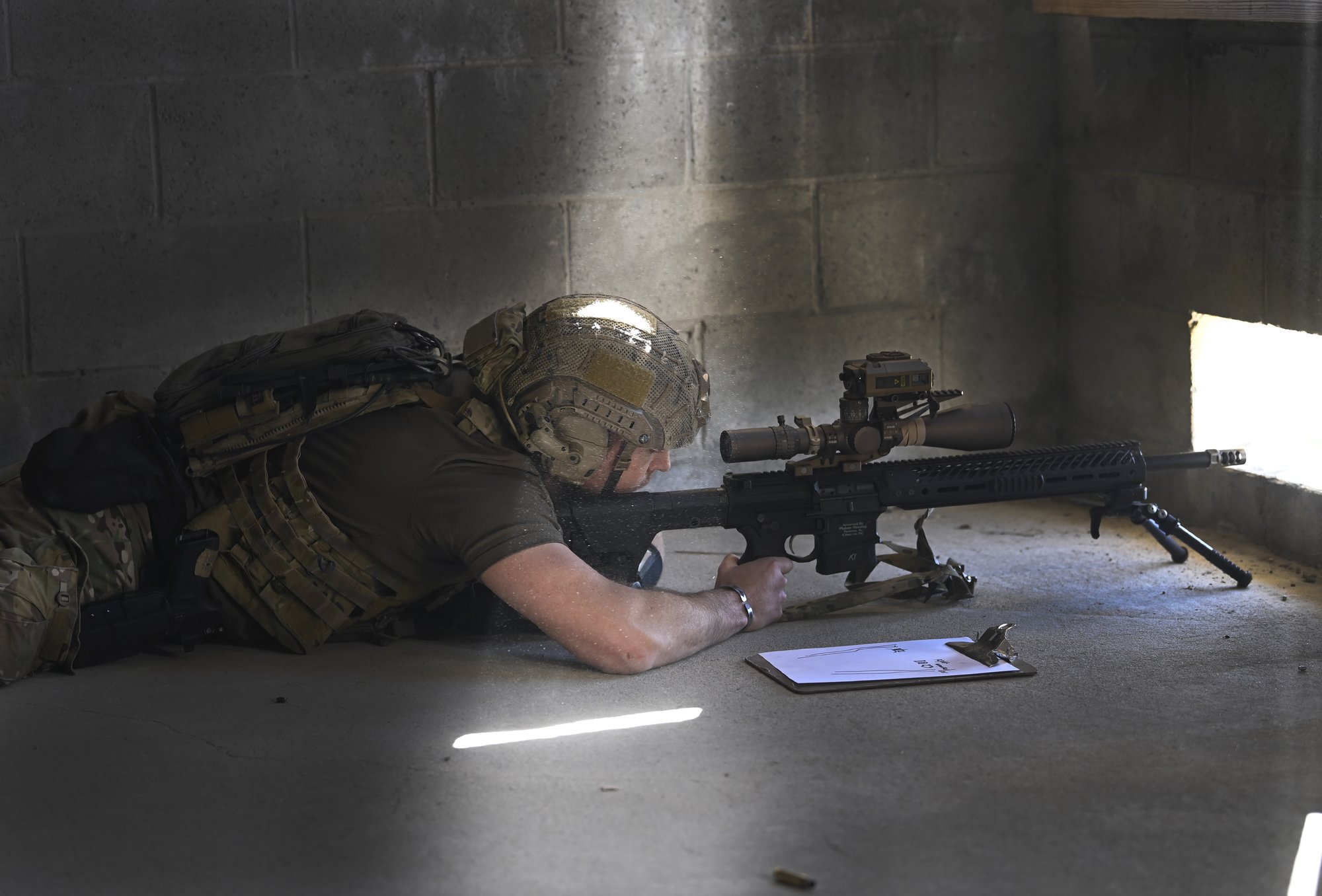 A competitor in the United States Army Special Operations Command (USASOC) International Sniper Competition looks through a riflescope while searching for long-distance targets at Fort Bragg, North Carolina, March 21, 2022. US Army photo by K. Kassens.