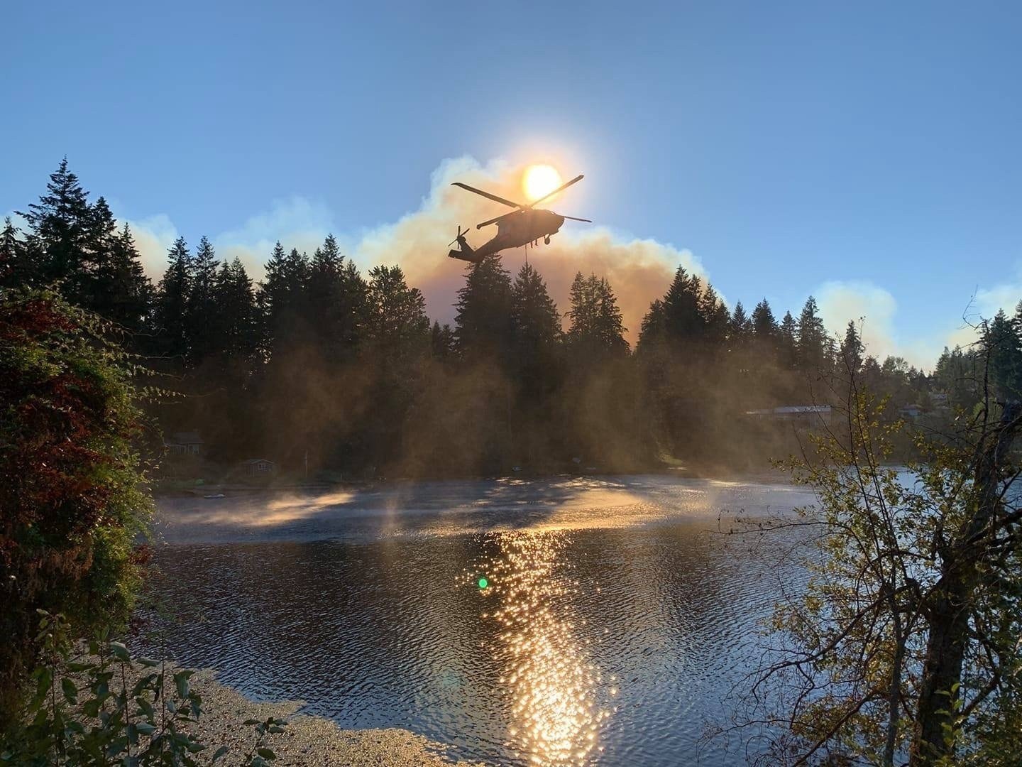 A Washington Army National Guard Black Hawk helicopter loads up a water bucket in a lake near Bonney Lake, Wash. on Sept 9, 2020. Washington National Guard flight crews dropped more than 280,000 gallons of water on the Sumner Grade Fire. Courtesy photo