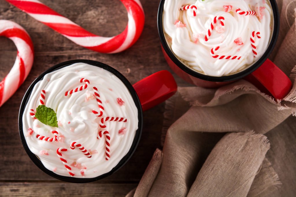 Peppermint coffee mocha for Christmas on wooden table. Top view