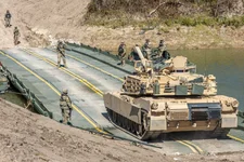An M1A2 Abrams main battle tank crosses an improved ribbon bridge during a gap crossing as part of Remagen Ready at Fort Hood, Texas, Oct. 26, 2022. The US recently pledged to send main battle tanks to Ukraine; Russia quickly followed with a bounty to destroy them. US Army photo by Sgt. Kaden Pitt.