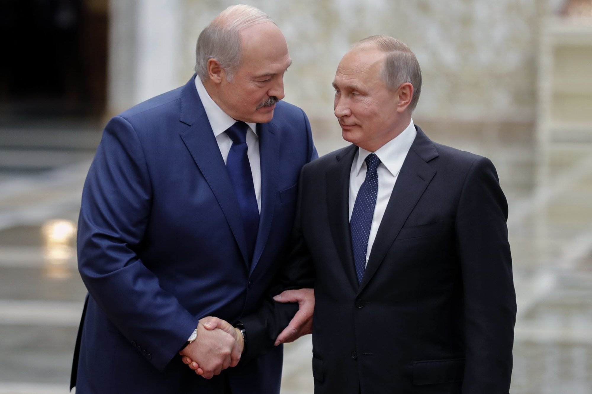 Belarus’ President Alexander Lukashenko (left) welcomes his Russian counterpart Vladimir Putin prior to the Collective Security Treaty Organisation summit in Minsk on Nov. 30, 2017.      MIKHAIL METZEL/AFP via Getty Images