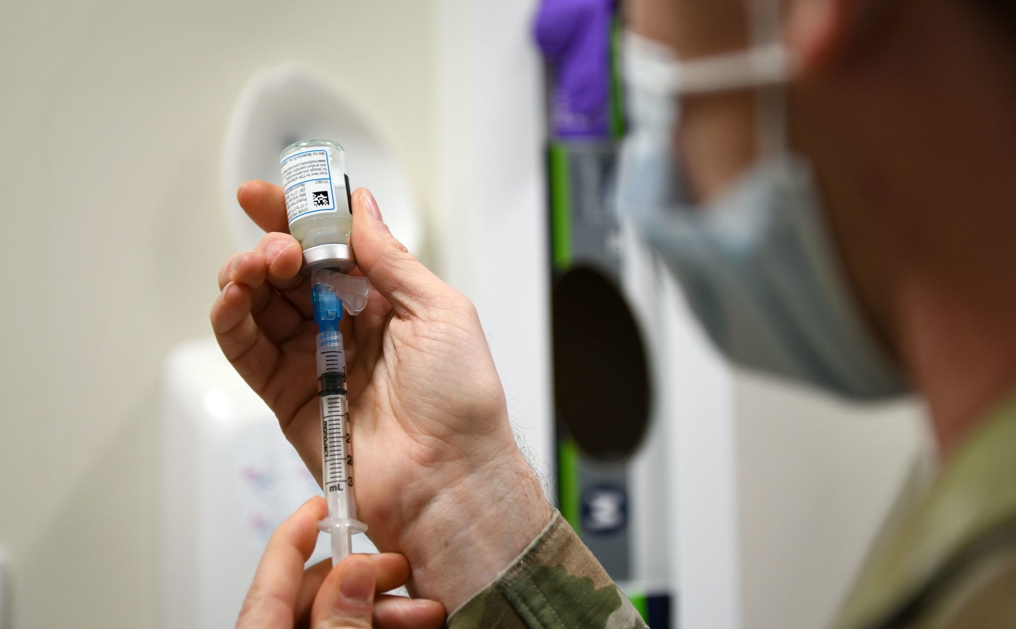 Technical Sgt. Justin Pribble, 48th Medical Group pediatrics/immunology flight chief, draws a sample of the COVID-19 vaccine at Royal Air Force Lakenheath, England, Dec. 29, 2020. Pribble was the technician responsible for administering the first COVID-19 vaccines at the 48th Fighter Wing.(U.S. Air Force photo by Senior Airman Madeline Herzog)