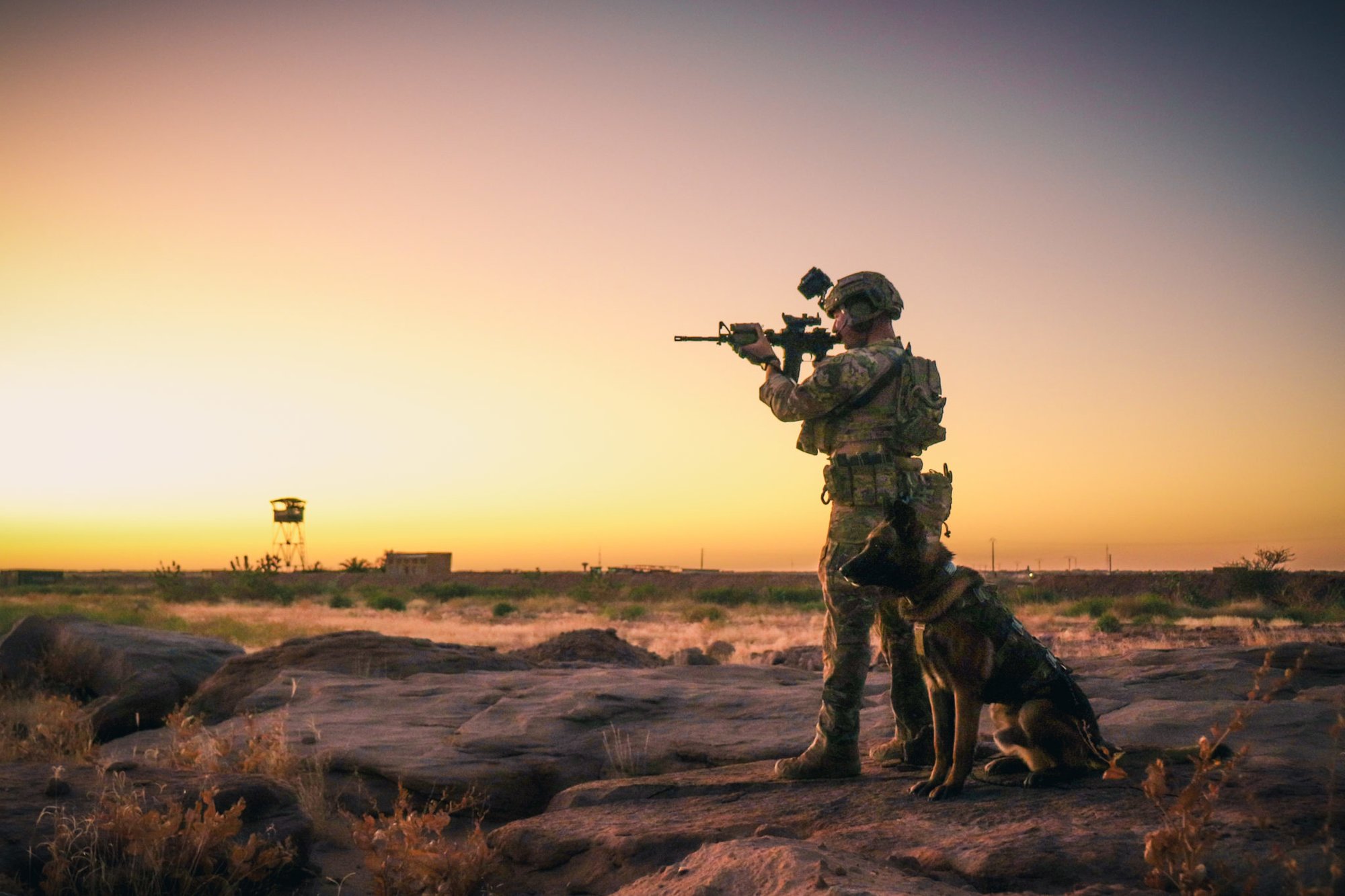 U.S. Air Force Senior Airman Cullen Thomas, 824th Expeditionary Base Defense Squadron military working dog handler, and his military working dog Klepa perform a perimeter check at Nigérien Air Base 201, Niger, Dec. 9, 2018. Photo by Staff Sgt. Daniel Asselta, courtesy of U.S. Air Force.