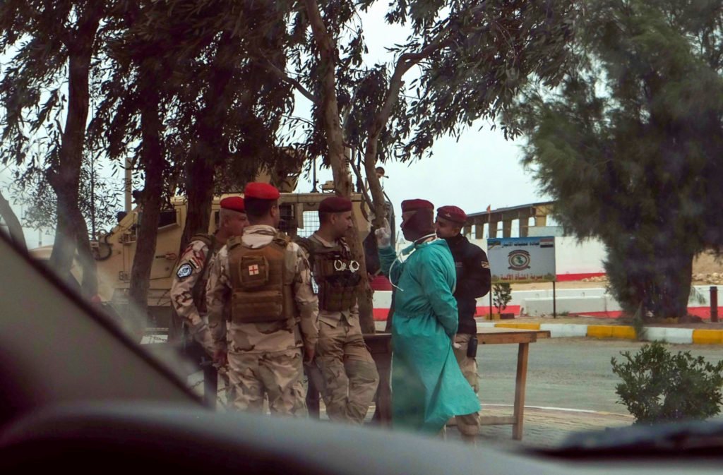 Iraqi troops guard the gate of a facility near Al Taqaddum Airbase in Iraq’s Anbar Province. Iraqis military officials have begun screening troops returning from leave. Photo by Kevin Knodell/Coffee or Die.