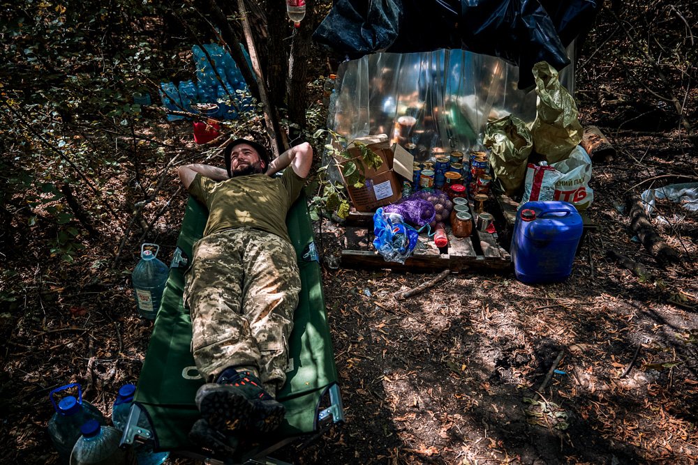 A Ukrainian soldier rests at his position on the frontline.