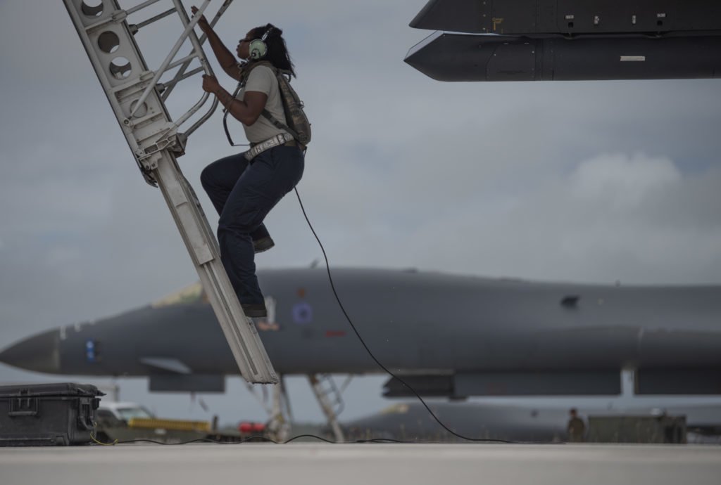 Senior Airman Raisa Ward, 9th Expeditionary Bomb Squadron Aircraft Maintenance Unit avionics technician, climbs into a 9th EBS B-1B Lancer to conduct maintenance at Andersen Air Force Base, Guam, May 5, 2020. Photo by Senior Airman River Bruce/U.S. Air Force.