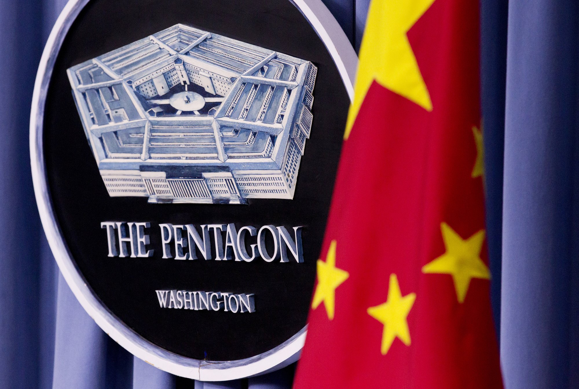 China's national flag is displayed next to the Pentagon logo at the Pentagon, Monday, May 7, 2012. The Pentagon will load up on advanced missiles, space defense and modern jets in its largest defense request in decades in order to meet the threat it perceives from China. The Defense Department's chief financial officer says the spending path will have the military's annual budget cross the $1 trillion threshold in just a matter of years. AP Photo by Manuel Balce Ceneta, File.