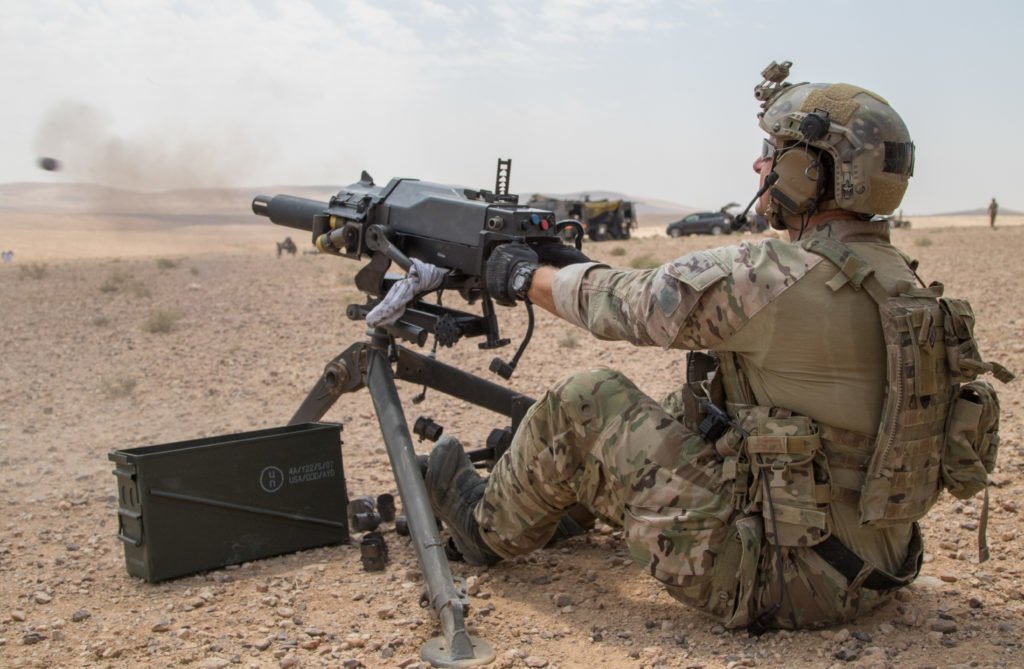 A soldier assigned to U.S. Army Special Operations Command demonstrates firing positions on the M320 40mm grenade launcher to a member of the Saudi Arabian Naval Special Forces during joint forces weapons training in a tactical training area in Amman, Jordan, Aug. 28, 2019, as part of Exercise Eager Lion 2019. Photo by Sgt. Devon Bistarkey/U.S. Army National Guard.