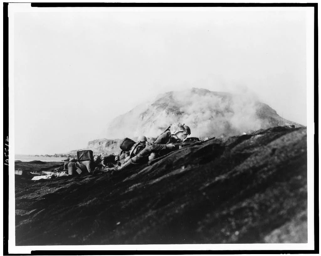 Marines of the 2nd Battalion, 27th Marines, 5th Marine Division get into defensive positions on Iwo Jima, 1945. Photo courtesy of the Library of Congress.