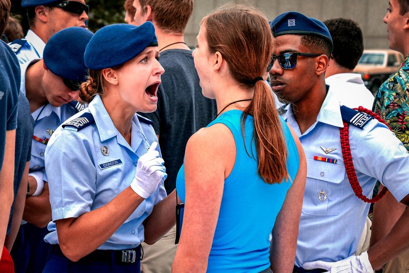 Cadet 2nd Class Annika Edgington, a Basic Cadet Training cadre member, instructs a basic cadet on Inprocessing Day