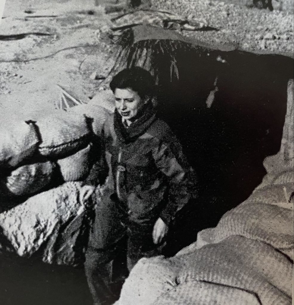 Friang exiting the foxhole at headquarters of the “Heavy Green” Company. Photo scanned from "Parachutes and Petticoats" by Brigitte Friang.