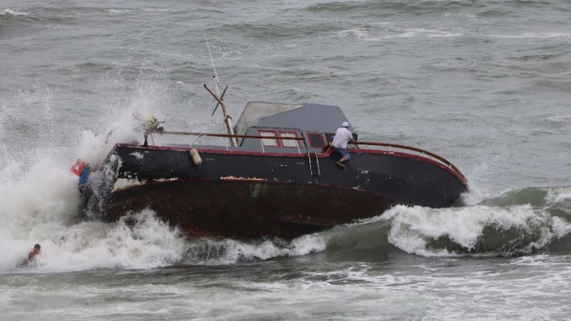 Undocumented migrants abandon the sinking Lucky Lady, a 40-foot fishing boat that wrecked on the reef off California's Point Loma on May 2, 2021. US Department of Justice photo.
