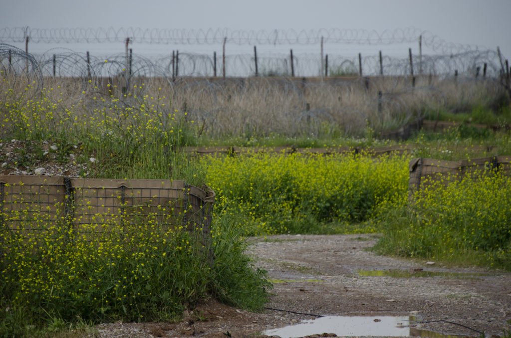 Flowers grow out of hesco barriers on the perimeter of K1. Photo by Kevin Knodell/Coffee or Die.