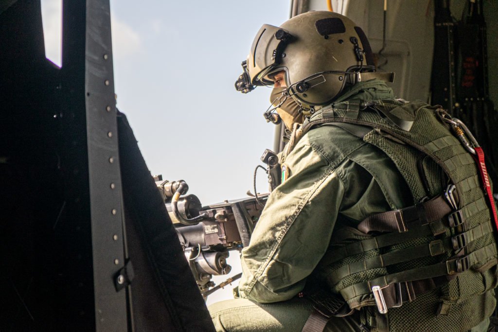 An Italian door gunner scans the horizon on a military flight to the American compound at K1 in Kirkuk. The Italian crew carries several American officers and a group of Kurdish journalists for the official handover of the American compound to Iraqi forces. Photo by Kevin Knodell/Coffee or Die.