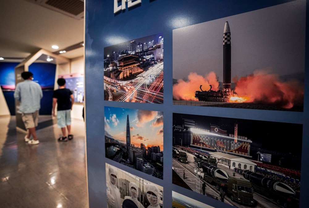 Photos showing North Korea's missiles, right, are displayed at the Unification Observation Post in Paju, South Korea.