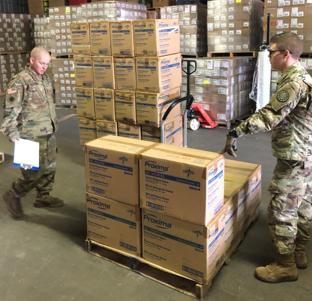 Soldiers from the Michigan National Guard assist Michigan Department of Health and Human Services with assembling and loading critical personal protective gear, such as gloves, gowns, and face shields, March 18, 2020. Once packaged, MDHHS will deliver the supplies to various local public health departments. Photo by Sgt. James Bennett, courtesy of the U.S. National Guard.