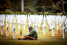 A man sits in the the American Cemetery during a ceremony to mark the 79th anniversary of the assault that led to the liberation of France and Western Europe from Nazi control, in Colleville-sur-Mer, Normandy, France, Tuesday, June 6, 2023. The American Cemetery is home to the graves of 9,386 United States soldiers. Most of them lost their lives in the D-Day landings and ensuing operations. AP photo by Thomas Padilla.