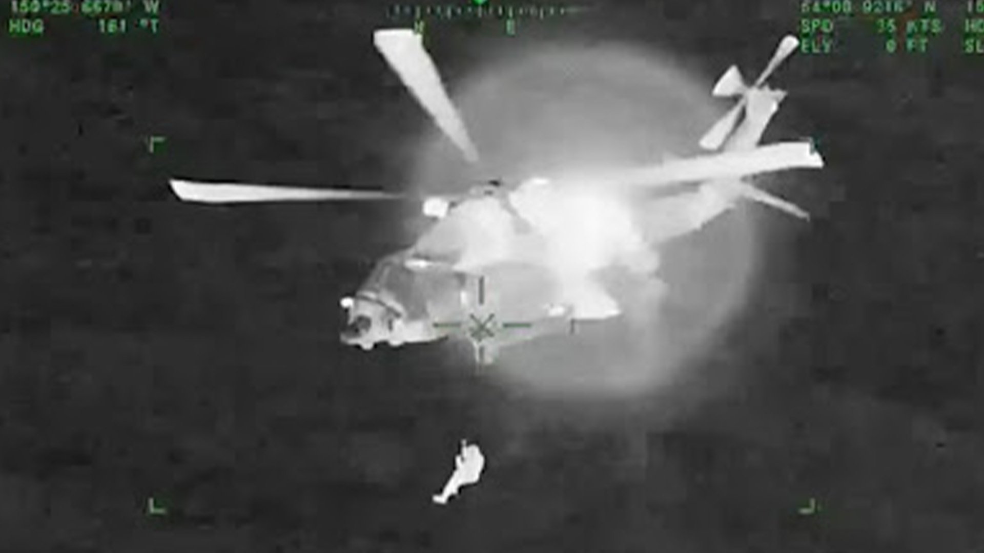 Aviation Survival Technician 2nd Class Tyler Stacey is hoisted up to the US Coast Guard Air Station Kodiak MH-60T Jayhawk on Oct. 4, 2022, more than 200 nautical miles south of Kodiak, Alaska. Screenshot from US Coast Guard video.