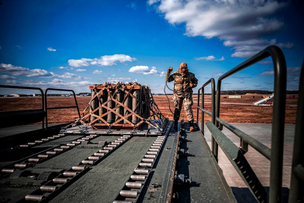 Air Force Airman Faith Grayson, 436th Aerial Port Squadron ramp operation specialist, loads cargo during a security assistance mission.