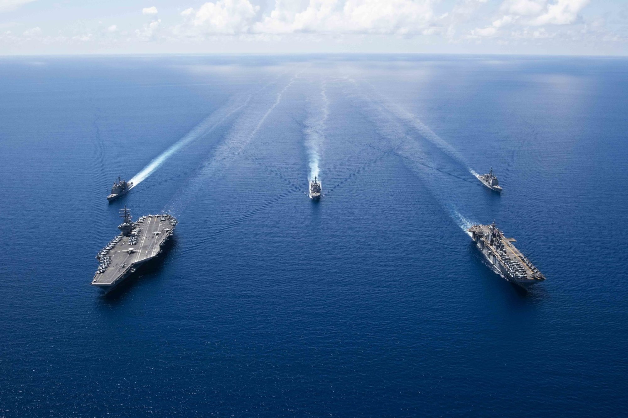 191006-N-VI515-0396 SOUTH CHINA SEA (October 6, 2019) Ships from Ronald Reagan Carrier Strike Group and Boxer Amphibious Ready Group sail in formation while conducting security and stability operations in the U.S. 7th Fleet area of operations. U.S. 7th Fleet is the largest numbered fleet in the world, and the U.S. Navy has operated in the Indo-Pacific region for more than 70 years, providing credible, ready forces to help preserve peace and prevent conflict. (U.S. Navy photo by Mass Communication Specialist 2nd Class Erwin Jacob V. Miciano)