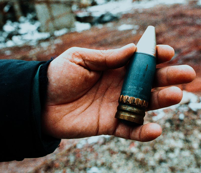 FILE - A member of a radiation team holds a 30mm armor-piercing shell containing depleted uranium, used by NATO during air strikes on Bosnia in 1995, which was found in a former military factory in the suburb of Vogosca, near Sarajevo, Jan. 15, 2001. (AP Photo/Hidajet Delic, File)