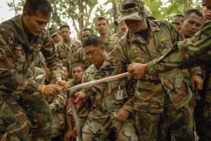 Royal Thai Marines skin the cobra.